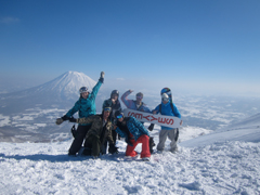 A group of skiers and snowboarder at the top of Niseko ski resort